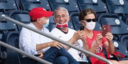 Mandatory Credit: Photo by Alex Brandon/AP/Shutterstock (10721001ct) Dr. Anthony Fauci, director of the National Institute of Allergy and Infectious Diseases, center, smiles as he watches an opening day baseball game between the Washington Nationals and the New York Yankees at Nationals Park, in Washington Yankees Nationals Baseball, Washington, United States - 23 Jul 2020